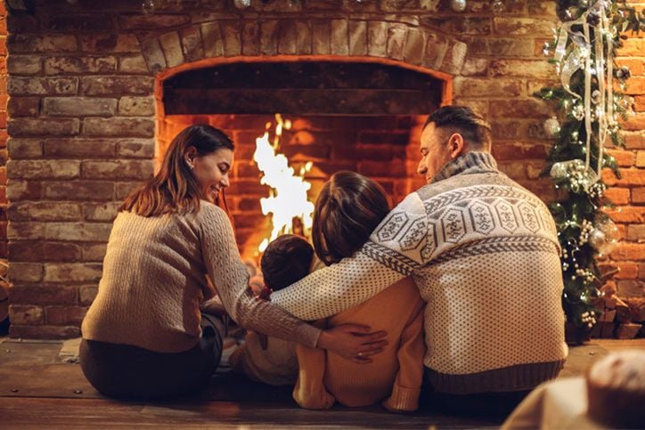 a family sitting by a fire